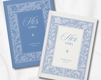 May include: Two wedding vow books, one light blue and one off-white, with floral border designs. The blue book reads "His Vows" and the off-white book reads "Her Vows". Both books have the names "Elodie & Louis" and a date.