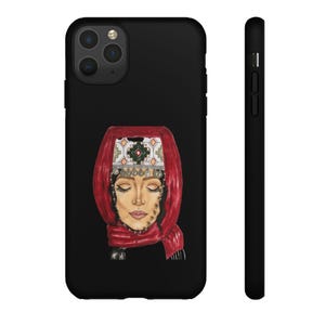 May include: Black phone case featuring a watercolor illustration of a woman wearing a red headscarf and traditional headwear. The design includes intricate details and a serene expression, perfect for those seeking cultural art.