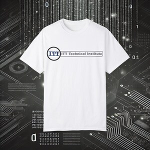 May include: White t-shirt with the text "ITT Technical Institute" in a black and blue design. The shirt has a crew neck and short sleeves. The background features a digital circuit board design.