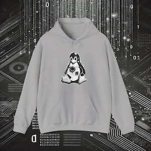 May include: A light gray hoodie with a kangaroo pocket and a drawstring hood. The front features a black and white graphic of a penguin with a flower-like design on its chest. The background has a digital circuit board design.