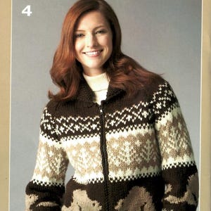 May include: A brown, beige, and white zip-up sweater with a geometric pattern and bear silhouettes. The sweater has a collared neckline and is worn over a white turtleneck. The number "4" is in the top left corner.