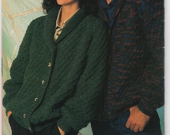 May include: A couple wearing knitted sweaters. The woman is wearing a dark green sweater with a shawl collar and buttons. The man is wearing a multi-colored sweater with a shawl collar. The woman is looking at the camera and the man is looking at the woman. The background is a light blue and white pattern.