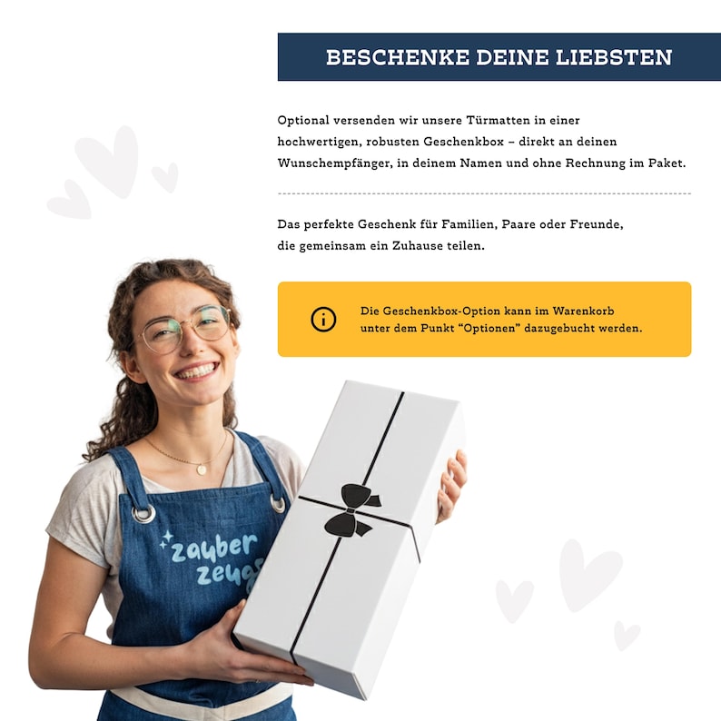 May include: A woman holding a white gift box tied with a black ribbon. The box has a black bow and is wrapped with black ribbon. The text on the box says "BESCHENKE DEINE LIEBSTEN". The woman is wearing an apron that says "zauber zeug".