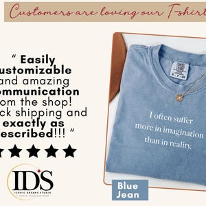May include: A blue jean t-shirt with the quote "I often suffer more in imagination than in reality." A gold necklace rests on the shirt. The image also includes customer reviews and the shop's logo.