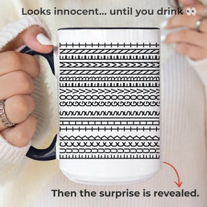 May include: White ceramic mug with a black handle and rim, decorated with black geometric patterns. The mug has the text "Looks innocent... until you drink" and "Then the surprise is revealed."