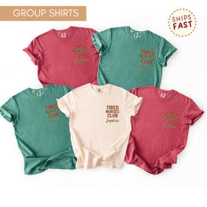 May include: A collection of five short-sleeved t-shirts in various colors: red, green, and cream. Each shirt features the text "TIRED NURSES CLUB" and the name "Sophia" printed on the front. The shirts are casual wear.