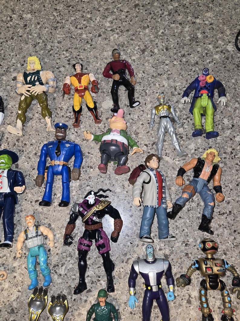 May include: A collection of colorful action figures, featuring various characters in dynamic poses. The figures showcase a range of designs, including superheroes, futuristic characters, and uniformed figures. The toys are made of plastic and are in various colors.