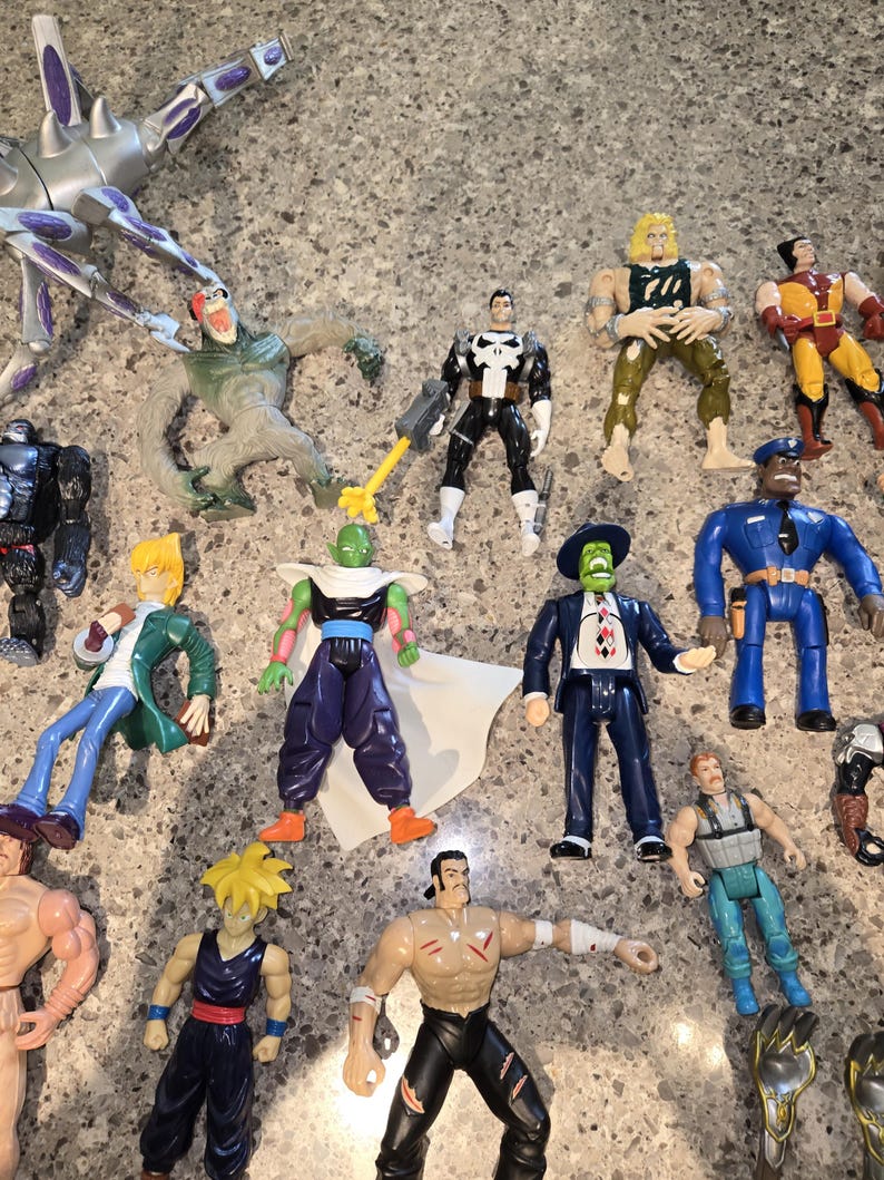 May include: A collection of colorful action figures, including characters from various franchises. The figures are in various poses and feature detailed designs. The figures are made of plastic and are of different sizes.