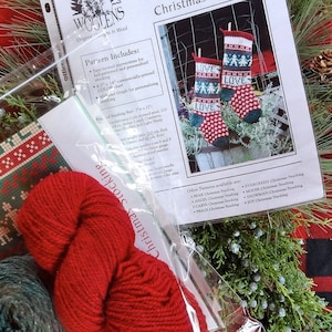 May include: A kit for knitting a Christmas stocking with the words "LOVE" on it. The kit includes red, green, and white yarn, a pattern, and a chart. The pattern is called "Annie's Woolens Love Christmas Stocking".