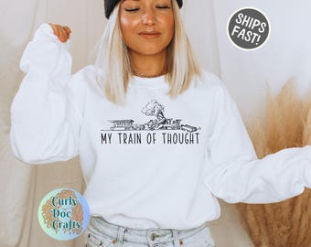 May include: White sweatshirt with a black and white illustration of a train and the text "My Train of Thought".
