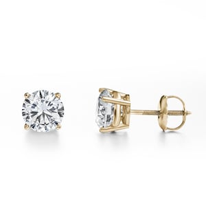 May include: A pair of round-cut diamond stud earrings in yellow gold. The clear diamonds are held by four prongs. The earrings feature a classic screw-back design for secure fastening. The earrings are a timeless jewellery item.