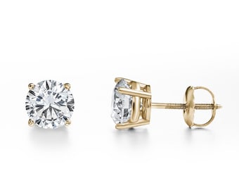 May include: A pair of round-cut diamond stud earrings in yellow gold. The clear diamonds are held by four prongs. The earrings feature a classic screw-back design for secure fastening. The earrings are a timeless jewellery item.