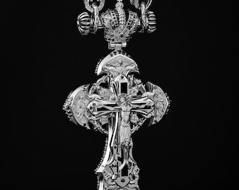 May include: Ornate silver cross pendant with intricate detailing, including a figure of Jesus Christ, a crown, and religious iconography. The pendant hangs from a detailed chain against a black background. The design is highly detailed and features a polished finish.