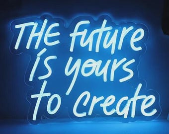 May include: A blue neon sign with the words "THE future is yours to create" in a white, handwritten-style font. The sign is mounted on a blue surface, creating a vibrant and motivational display.