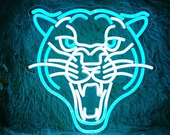 May include: A neon sign shaped like a tiger's face with a white outline and a blue glow. The tiger's mouth is open and its eyes are wide.