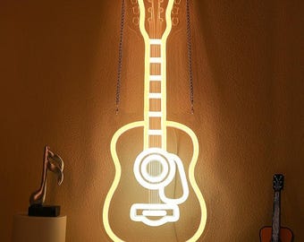 May include: A neon guitar-shaped wall light in a warm yellow color. The light is hanging from two chains. A musical note sculpture and a wooden guitar are also visible.