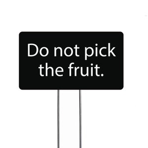 May include: A black sign with white text that reads "Do not pick the fruit."