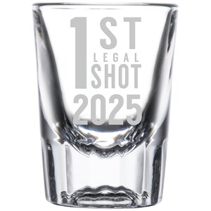 May include: A clear glass shot glass with the text "1st Legal Shot 2025" etched on the side.