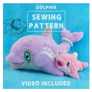 May include: A purple and gray plush dolphin with a pink plush baby dolphin. The larger dolphin has a blue and white wave design on its side. The text "DOLPHIN SEWING PATTERN" is in a white box with a stitched border. The text "VIDEO INCLUDED" is below the dolphins.