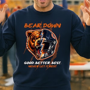 May include: Navy blue sweatshirt with a graphic featuring a bear head and a football helmet split down the middle. The text "BEAR DOWN" is above the image, and "GOOD. BETTER. BEST. NEVER LET IT REST." is below.
