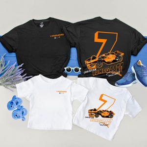 May include: Black and white t-shirts with the text "Lundgaard AI" and a racing car design. The number 7 is featured on the back of one shirt. Blue sneakers and sunglasses are also in the image.