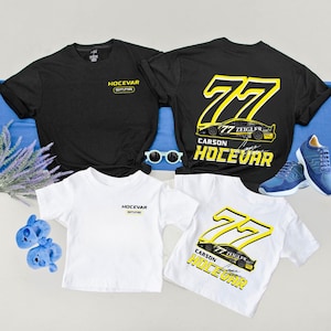 May include: Black and white t-shirts with the text "HOCEVAR" and "77 CARSON HOLEVAR" in yellow. A pair of blue sneakers and sunglasses are also in the image. The shirts are on a blue surface.