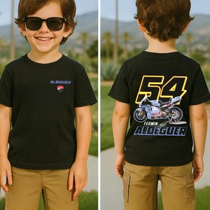 May include: Black t-shirt with the text "ALDEGUER" and a shield logo on the front. The back of the shirt features the number "54" in yellow, a motorcycle graphic, and the name "FERMIN ALDEGUER".