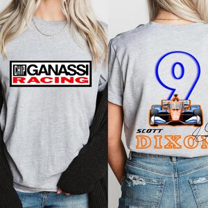 May include: A gray t-shirt featuring the "Chip Ganassi Racing" logo in a black and red rectangle on the front. The back displays a blue number 9 with a race car graphic and "Scott Dixon" in orange.