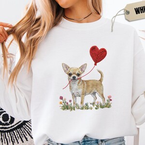 Faux Yarn Chihuahua shirt, puppy love shirt, yarn heart balloon, valentine dog tee style for tiny-dog fans. A cute Chihuahua with big ears holding a red yarn heart balloon string, finished with soft floral details for everyday wear.