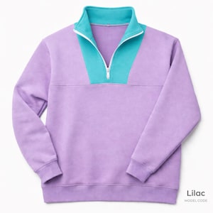 May include: A lilac sweatshirt with a teal and white colour block design on the collar and upper chest. The sweatshirt features a quarter-zip closure and long sleeves. The text "Lilac" and "MODEL CODE" are in the bottom right corner.