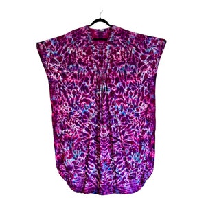 May include: A purple and blue tie-dye tunic with a V-neck and short sleeves.