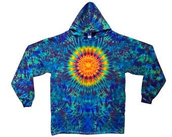 May include: A long-sleeved hooded sweatshirt with a tie-dye pattern in shades of blue, green, and orange. The center of the shirt features a circular design with a bright orange center and yellow, green, and blue radiating outwards.