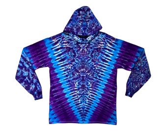 May include: A long-sleeved hoodie with a striking tie-dye design. The garment showcases a V-shaped pattern in blue and purple hues, with the colours merging seamlessly. It includes a hood and long sleeves, suitable for relaxed attire.