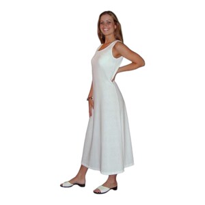May include: A sleeveless, white dress with a scoop neckline and a flowing A-line skirt. The dress is ankle-length and appears to be made of a textured fabric. The model is wearing white sandals.