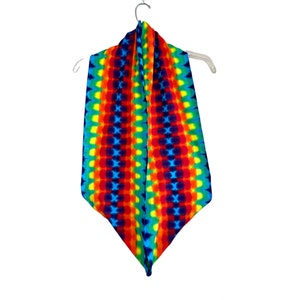 May include: A rainbow tie-dye fleece scarf with a geometric pattern. The scarf is folded in half and hanging on a hanger.