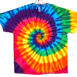 May include: A tie-dye t-shirt with a rainbow spiral pattern. The colors are bright and vibrant, including blue, green, yellow, orange, red, and purple.