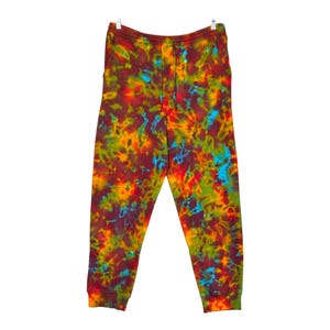 May include: Tie-dye sweatpants in a vibrant mix of red, orange, yellow, green, and blue.