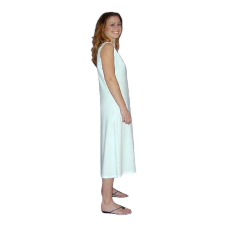May include: A sleeveless, light-colored dress with a knee-length hem. The dress has a simple, flowing design. The person in the image is wearing black sandals. The background is plain white.
