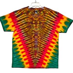 May include: A tie-dye t-shirt with a vibrant yellow, red, and green color scheme. The shirt features a unique, symmetrical pattern with a dark brown center.
