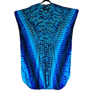 May include: A blue and black tie-dye kaftan with a V-neckline. The kaftan has a flowing, loose fit and is made of a soft, lightweight fabric.