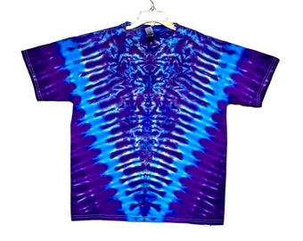May include: A tie-dye t-shirt with a blue and purple swirl pattern. The shirt has short sleeves and a crew neck.