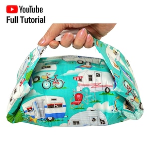 May include: A turquoise fabric lunch bag with a white handle and a colorful print of vintage campers, bicycles, and outdoor furniture. The bag is folded and ready to be used.  YouTube Full Tutorial.
