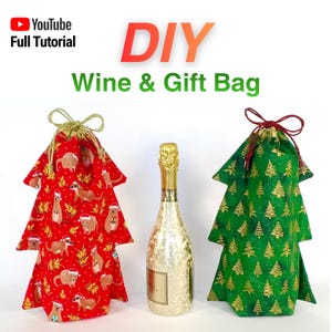 May include: DIY Christmas wine and gift bags shaped like Christmas trees. One red bag has a meerkat pattern, and the other is green with gold Christmas trees. A bottle of champagne is in the centre.