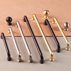 May include: Assortment of cabinet hardware in black, silver, and gold finishes.  The hardware includes pulls and knobs in various sizes.
