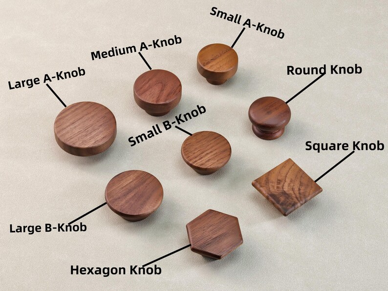May include: A selection of wooden cabinet knobs in different shapes and sizes, including round, square, and hexagonal designs. The knobs are labelled with sizes such as "Large A-Knob" and "Small B-Knob". The wood grain is visible on each knob.