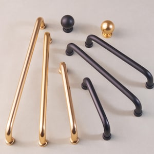 May include: Assortment of cabinet hardware in gold and black finishes.  The hardware includes pulls and knobs in various sizes.
