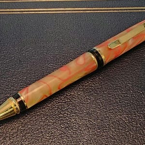 Red Lines swirling in Cream colored Acrylic Makes this a Stunning Ballpoint pen.
