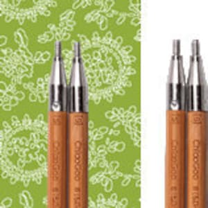 May include: A set of two interchangeable bamboo knitting needles. The needles are 3.75 mm in size and are made by ChiaoGoo. The needles are silver and have a brown bamboo shaft. The needles are packaged in a clear plastic bag with a white label that says "ChiaoGoo SPIN Bamboo Interchangeables".