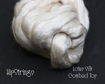 May include: A close-up of a bundle of off-white Lotus Silk Combed Top. The silk is soft and fluffy, and it is perfect for spinning or weaving.