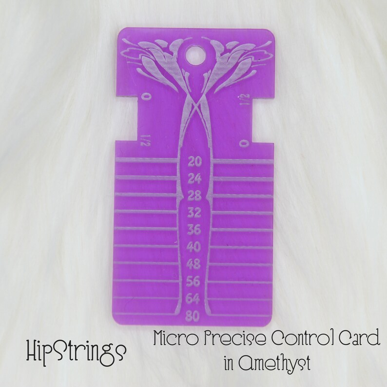 May include: A purple acrylic Micro Precise Control Card featuring etched measurement markings and numbers ranging from 20 to 80. The tool includes a circular hole at the top, symmetrical side cutouts, and the text HipStrings Micro Precise Control Card in Amethyst.